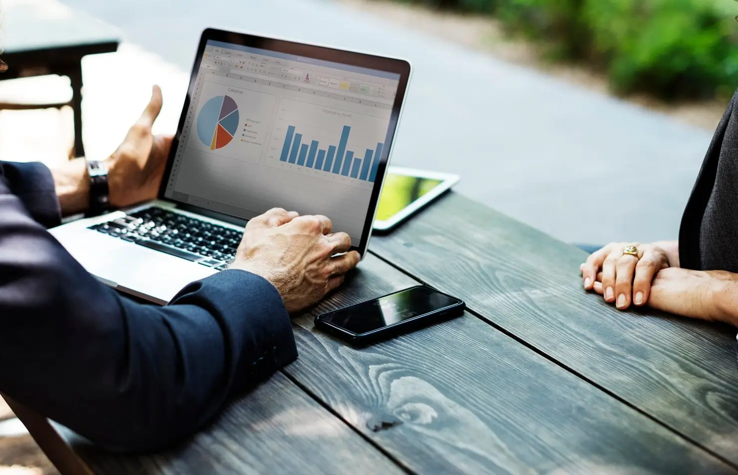 Real estate business owner and analyst reviewing marketing performance data